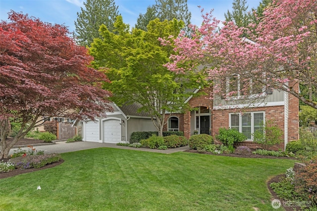 view of front of property with brick siding, a garage, a front lawn, and driveway