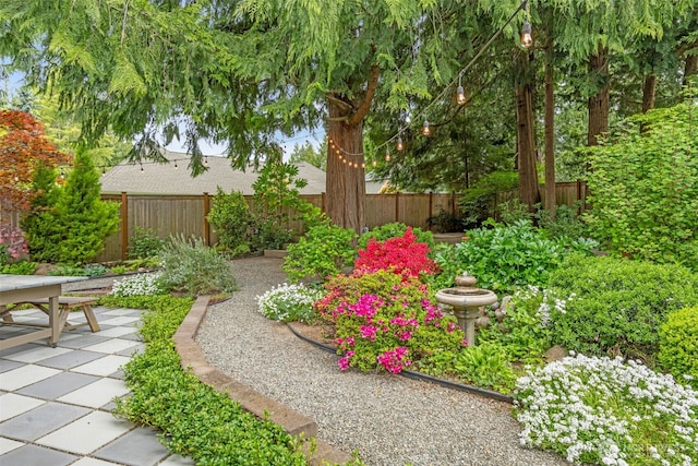view of yard with a patio, a fenced backyard, and outdoor dining area