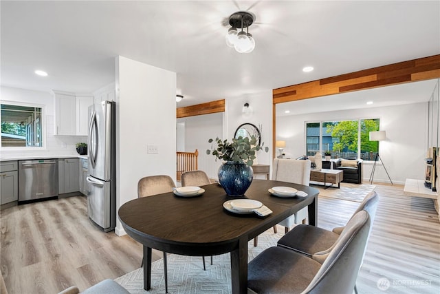 dining room with light wood finished floors and recessed lighting