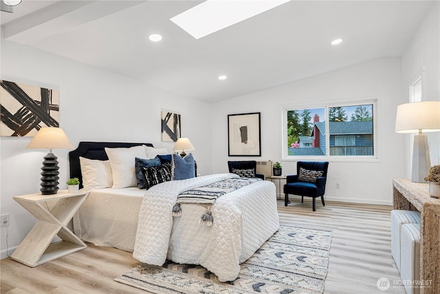 bedroom featuring light wood finished floors, lofted ceiling with skylight, baseboards, and recessed lighting