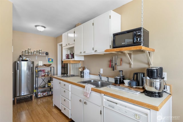 4375 Erin St, Port Townsend, WA 98368 - kitchen featuring white dishwasher, open shelves, freestanding refrigerator, a sink, and black microwave