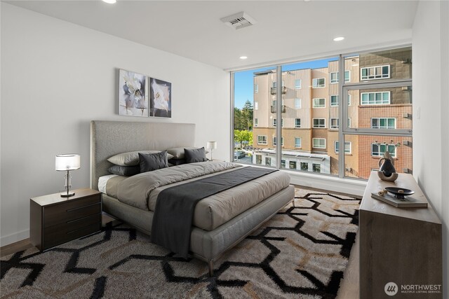 bedroom featuring recessed lighting, baseboards, wood finished floors, and visible vents