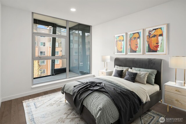 bedroom with baseboards, recessed lighting, wood finished floors, and multiple windows