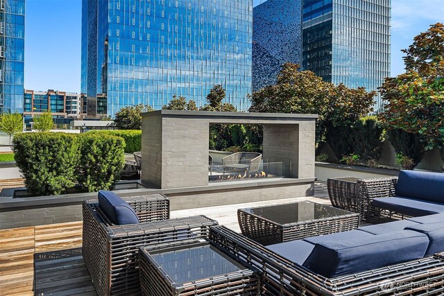 view of patio featuring a city view and an outdoor living space with a fireplace