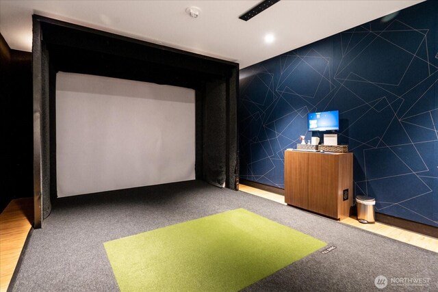 recreation room with carpet floors, golf simulator, and tile walls
