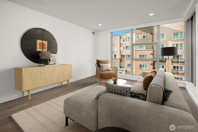 living area with baseboards, recessed lighting, and wood finished floors