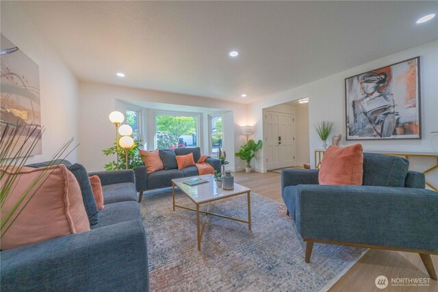 living area featuring wood finished floors, recessed lighting, and baseboards