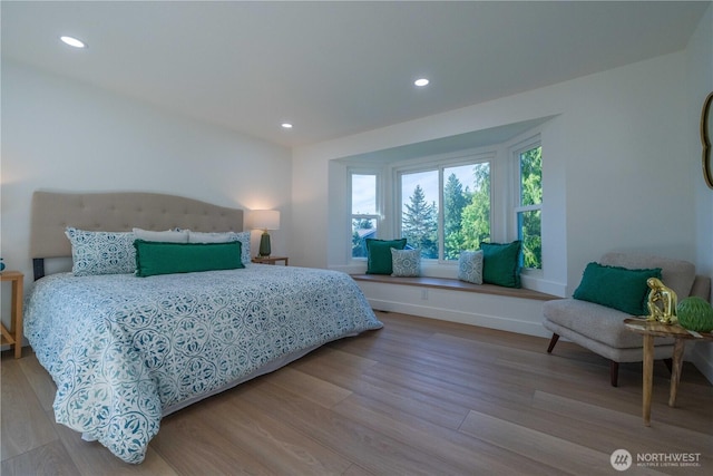 bedroom with wood finished floors, recessed lighting, and baseboards