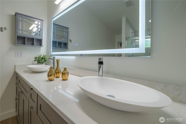 bathroom featuring double vanity and lofted ceiling
