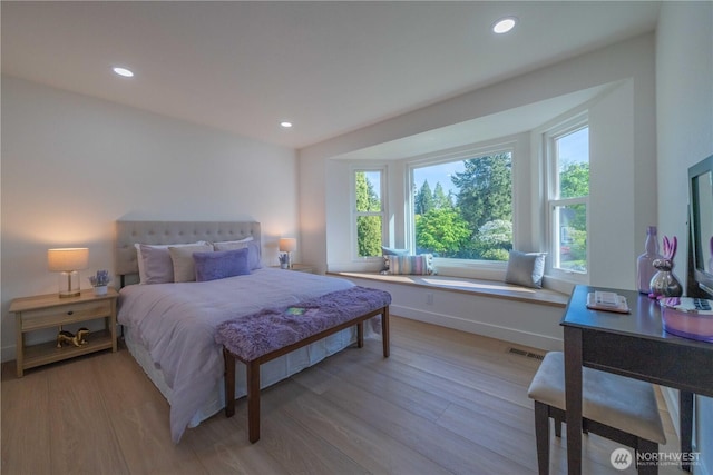 bedroom with light wood-style floors, recessed lighting, and baseboards