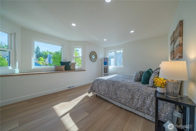 bedroom with wood finished floors, recessed lighting, and baseboards