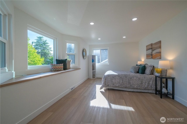 bedroom with wood finished floors, recessed lighting, and baseboards
