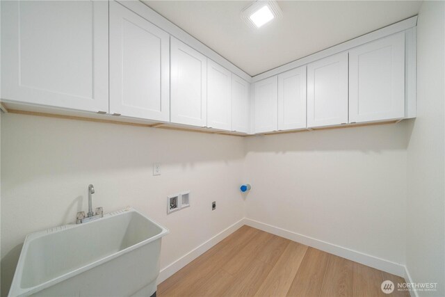 washroom featuring light wood-style floors, hookup for a washing machine, cabinet space, baseboards, and electric dryer hookup