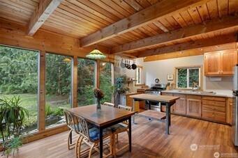 interior space with wooden ceiling, beamed ceiling, and a wooden deck