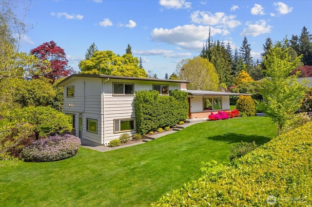 back of property with a lawn