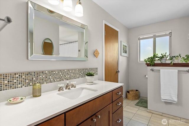 full bath featuring vanity, tile patterned flooring, and tasteful backsplash