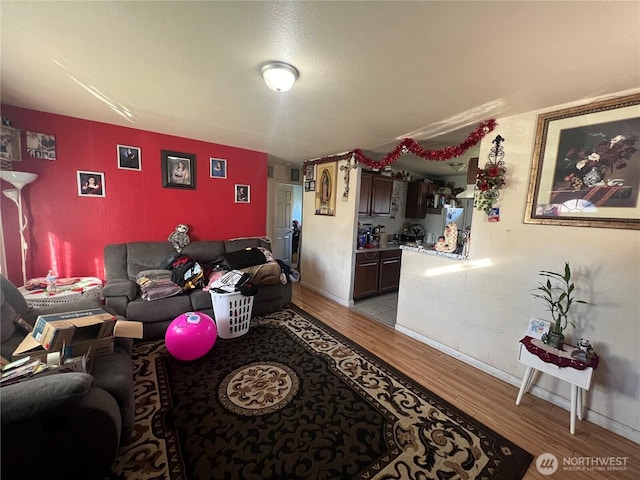 living room with baseboards and light wood-style flooring