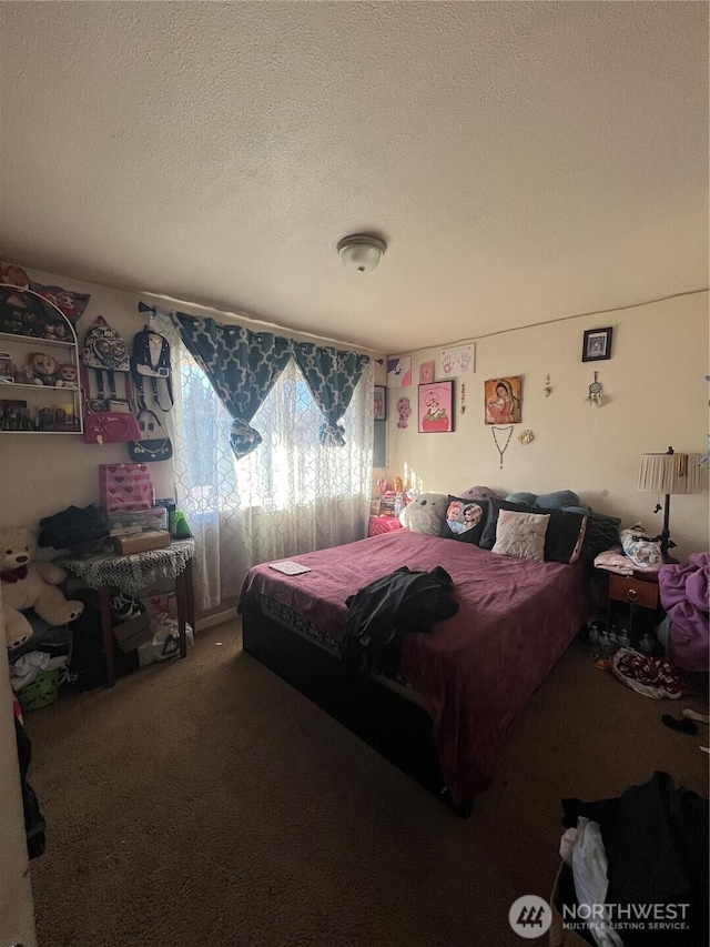 carpeted bedroom with a textured ceiling