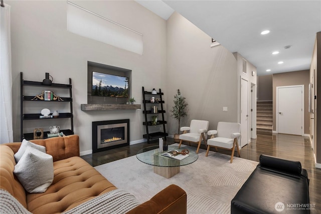 11508 SE 83rd St, Newcastle, WA 98056 - living area with recessed lighting, baseboards, a glass covered fireplace, stairs, and wood finished floors