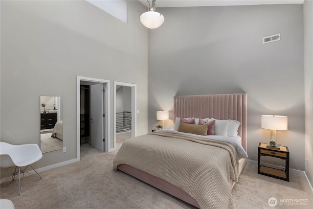 11508 SE 83rd St, Newcastle, WA 98056 - bedroom with carpet, a walk in closet, visible vents, baseboards, and a towering ceiling