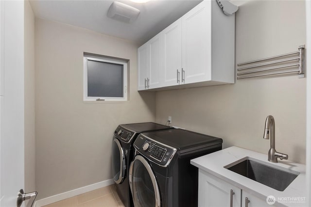 11508 SE 83rd St, Newcastle, WA 98056 - washroom with a sink, cabinet space, independent washer and dryer, light tile patterned floors, and baseboards