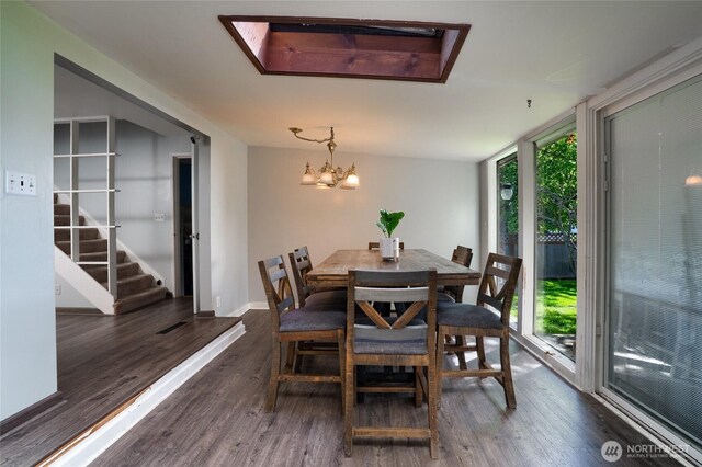 1705 36th St, Anacortes, WA 98221 - dining room featuring plenty of natural light, a chandelier, dark wood-type flooring, and baseboards