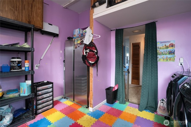 1705 36th St, Anacortes, WA 98221 - playroom featuring light floors, washer and clothes dryer, and baseboards