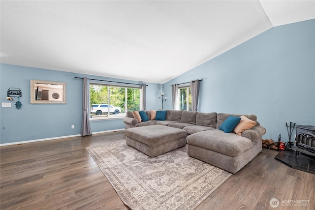 living area with baseboards, wood finished floors, and lofted ceiling