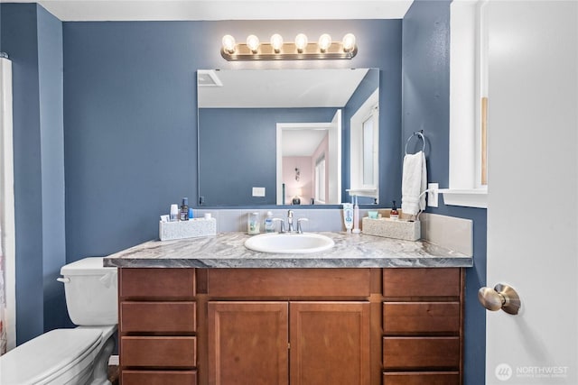 bathroom featuring vanity and toilet