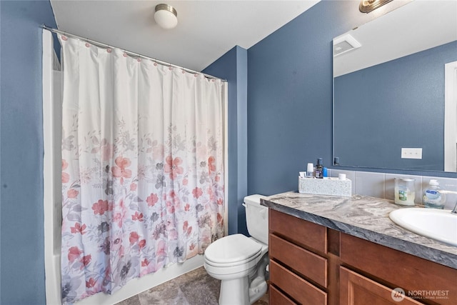 full bathroom with vanity, toilet, and shower / tub combo