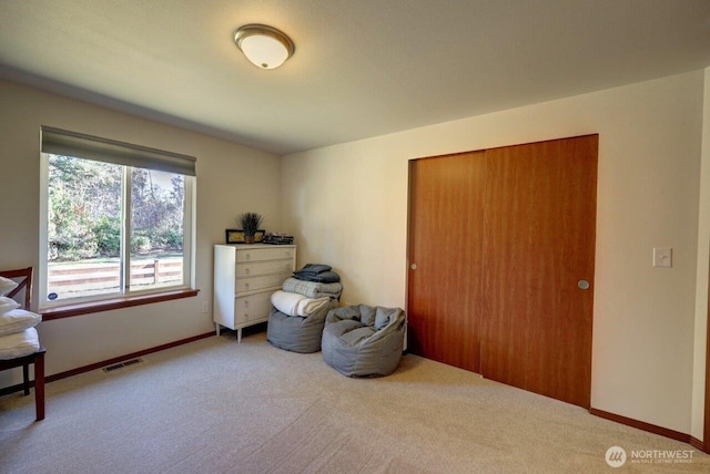 carpeted bedroom featuring baseboards and visible vents