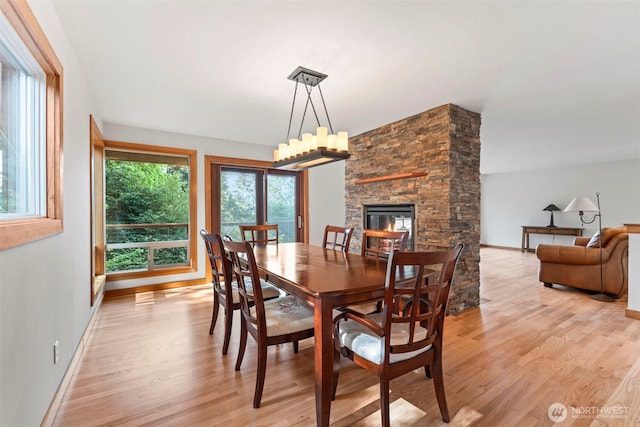 12105 SE 23rd St, Bellevue, WA 98005 - dining space featuring baseboards, light wood finished floors, and a fireplace