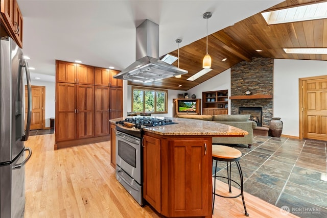 12105 SE 23rd St, Bellevue, WA 98005 - kitchen with a kitchen island, a stone fireplace, island range hood, wooden ceiling, and stainless steel appliances
