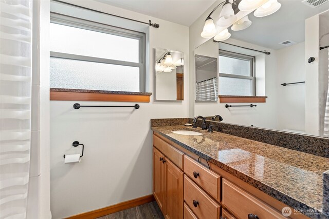 12105 SE 23rd St, Bellevue, WA 98005 - full bath with visible vents, baseboards, wood finished floors, and vanity
