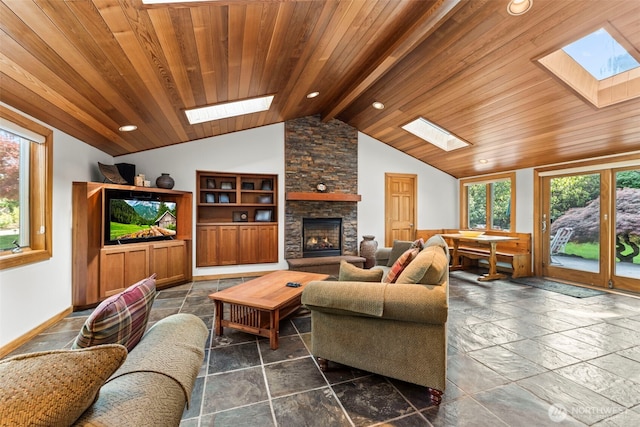 12105 SE 23rd St, Bellevue, WA 98005 - living room featuring a fireplace, recessed lighting, wood ceiling, lofted ceiling with skylight, and stone tile flooring