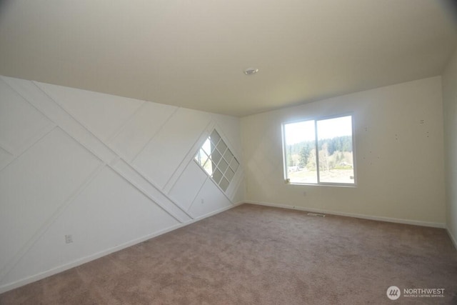 additional living space with baseboards, carpet, and visible vents