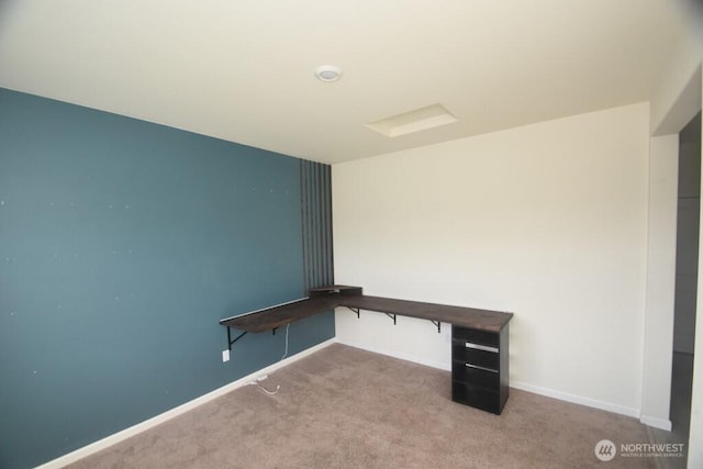 unfurnished office with baseboards and carpet
