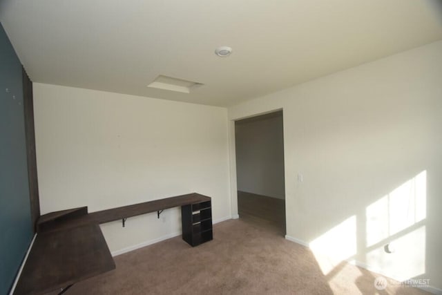 unfurnished office featuring baseboards and carpet flooring