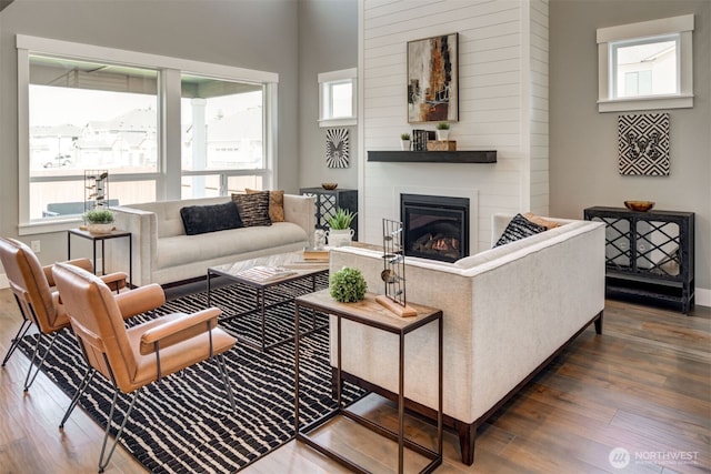 9319 129th Street Ct NW, Gig Harbor, WA 98329 - living room featuring wood finished floors, a healthy amount of sunlight, and a fireplace