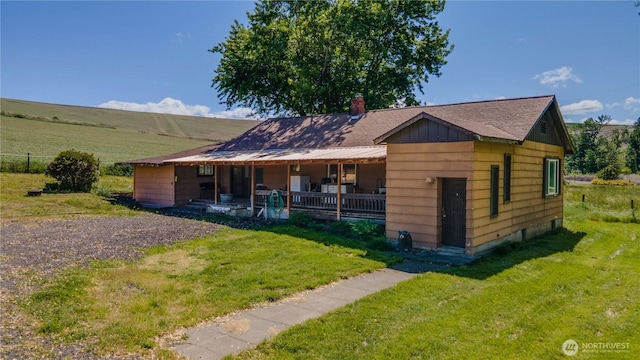 153 Biscuit Ridge Rd, Dixie, WA 99329 - bungalow-style home featuring covered porch, a front yard, and a chimney