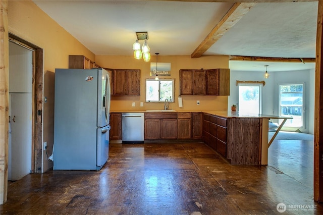 153 Biscuit Ridge Rd, Dixie, WA 99329 - kitchen featuring appliances with stainless steel finishes, a peninsula, a sink, beamed ceiling, and decorative light fixtures