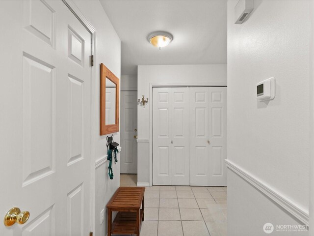 foyer with baseboards and light tile patterned floors