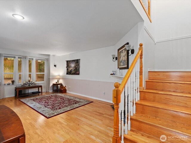 interior space featuring wood finished floors and stairway