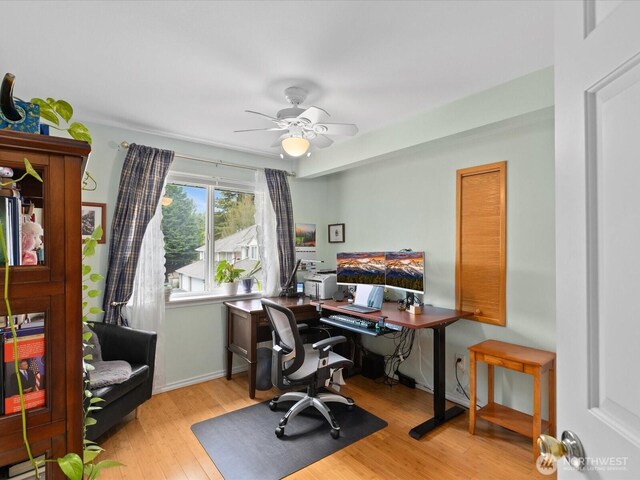 office area with baseboards, a ceiling fan, and wood finished floors