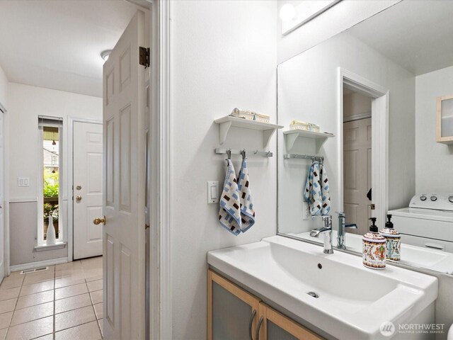 bathroom with tile patterned floors, visible vents, baseboards, and vanity