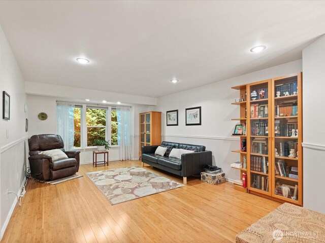 living room featuring recessed lighting, baseboards, and wood finished floors