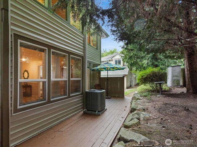wooden deck featuring cooling unit