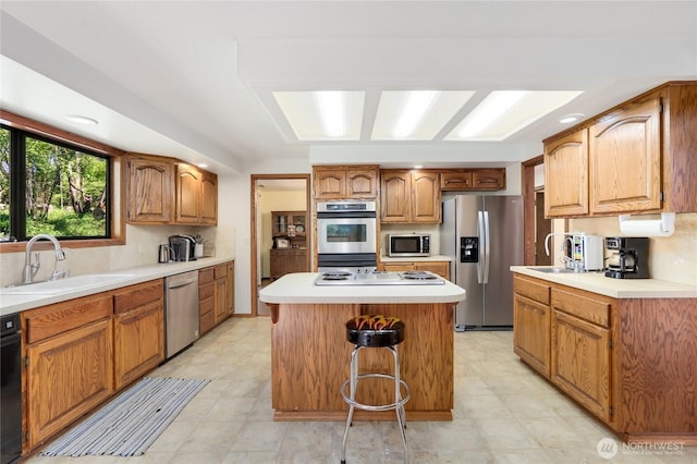 1614 Mckinnon Dr, Oak Harbor, WA 98277 - kitchen featuring appliances with stainless steel finishes, a sink, a kitchen island, and light countertops