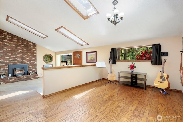 1614 Mckinnon Dr, Oak Harbor, WA 98277 - living area featuring a skylight, vaulted ceiling, wood finished floors, and a chandelier