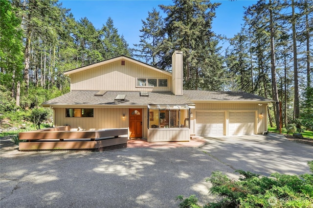 1614 Mckinnon Dr, Oak Harbor, WA 98277 - view of front of property with a garage, a chimney, driveway, and roof with shingles